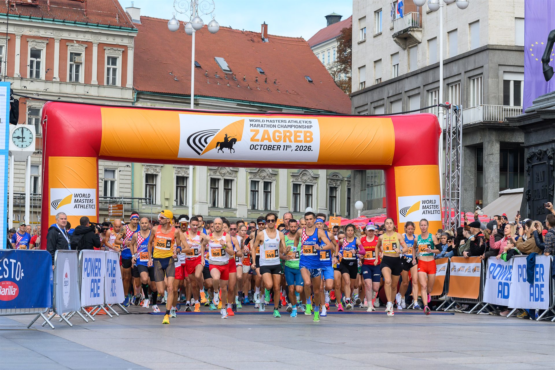 Runners starting the World Masters Athletics Marathon Championship under the start arch on Ban Josip Jelačić Square in Zagreb